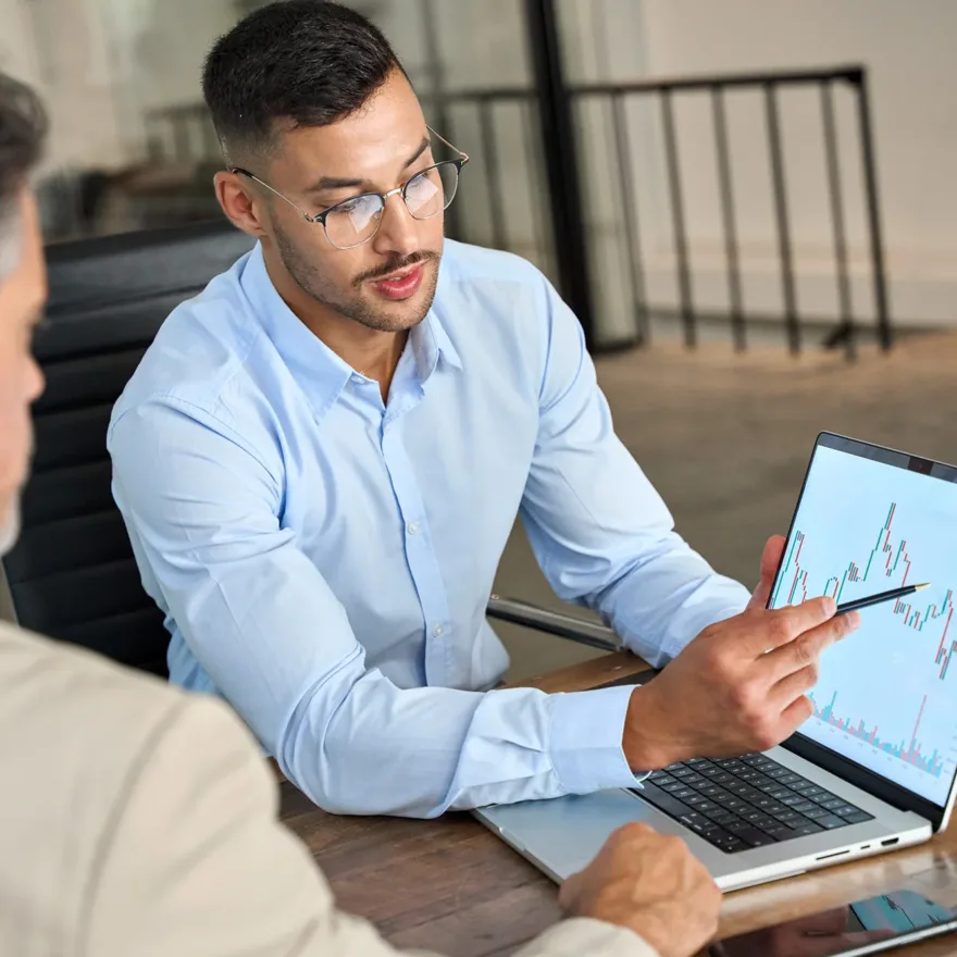2 men looking at laptop